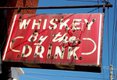 Whiskey by the drink sign at Shirley Mae's